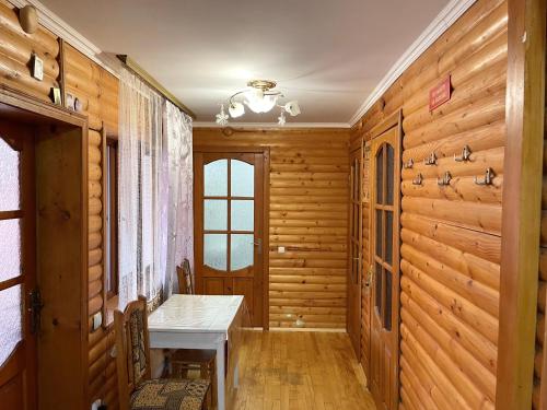 a hallway with wooden walls and a table and a window at Садиба Мигове in Migovo