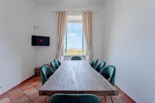 a table and chairs in a room with a window at The Attico: best view of Rome in Rome