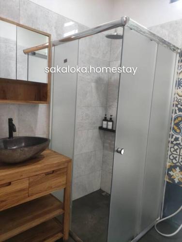 y baño con lavabo y ducha. en SakaLoka Villa - Banguntapan Yogyakarta, en Yogyakarta