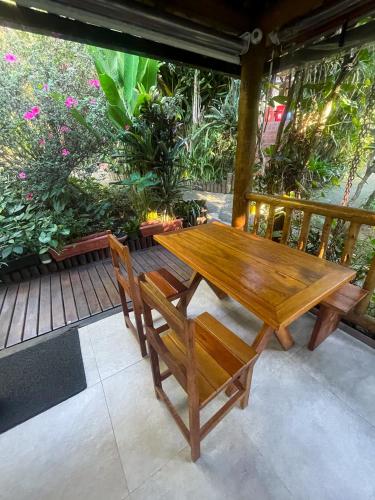 a wooden table and chairs on a patio at Pousada Albatroz in Abraão