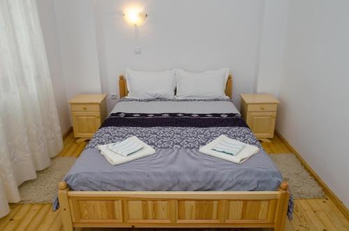 a bedroom with a bed with two towels on it at Guest House JoJi in Sapareva Banya