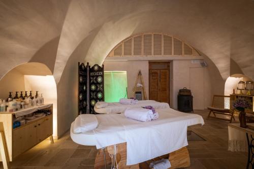 a room with three beds and a wine cellar at Nohasi Palace Lifestyle Hotel & SPA in Noha