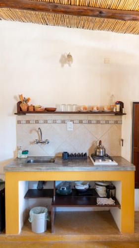 a kitchen with a sink and a counter top at Posada Suri Huasi in Tilcara