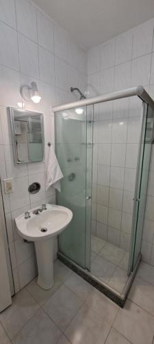 y baño con ducha acristalada y lavamanos. en Sofisticado Ambente A 1 cuadra de la playa Cod 1001, en Río de Janeiro