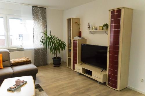 a living room with a flat screen tv in a entertainment center at Ferienwohnung Obernosterer in Medebach