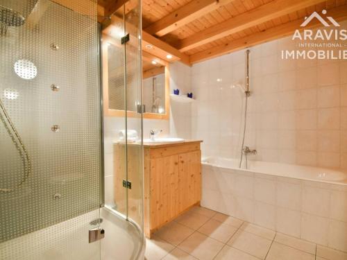 a bathroom with a shower and a tub and a sink at Appartement Le Grand-Bornand, 5 pièces, 8 personnes - FR-1-391-10 in Le Grand-Bornand