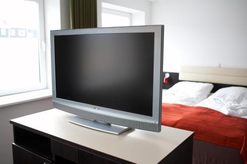 a computer monitor sitting on a table in a bedroom at Hotel Tórshavn in Tórshavn