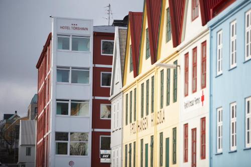 a row of colorful buildings in a city at Hotel Tórshavn in Tórshavn