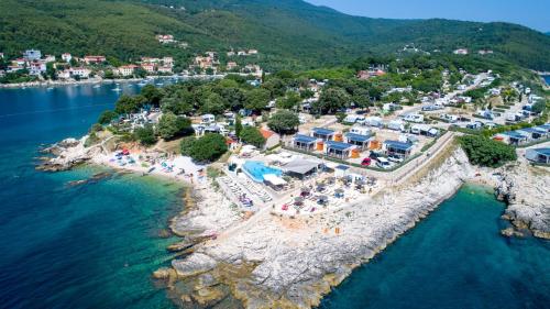 an aerial view of a resort on a rocky island in the water at Marina Camping Resort by Valamar in Rabac