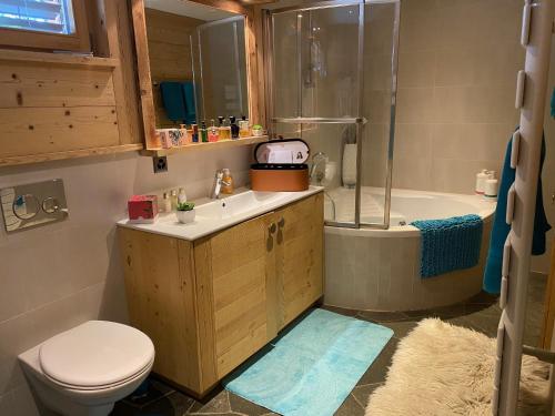 a bathroom with a toilet and a sink and a shower at B&B rooms within a modern family chalet with direct access to ski area in Verbier in Verbier