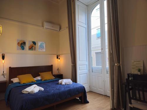 a bedroom with a bed with towels on it at Giardino Siciliano B&B in Catania