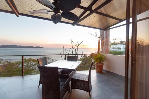 a dining room with a table and a ceiling fan at Luxury Flamingo villa with outdoor bar - pool and magnificent views in Playa Flamingo
