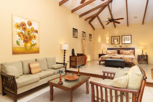 a living room with a couch and a bed at Luxury Flamingo villa with outdoor bar - pool and magnificent views in Playa Flamingo