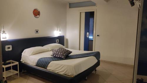 a bed with two pillows on it in a room at Hotel Daytona Palace in Casoria