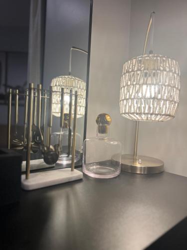 a table with two lamps and a light fixture at Cozy Mountain View Condo in Vernon Township
