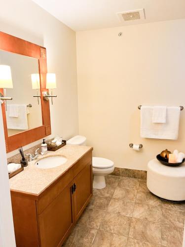 a bathroom with a toilet and a sink and a mirror at Cozy Mountain View Condo in Vernon Township