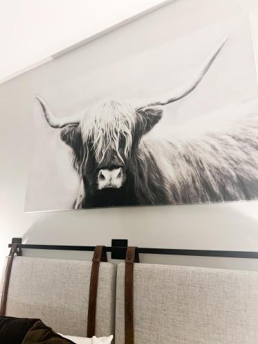 a painting of a cow hanging on a wall at Cozy Mountain View Condo in Vernon Township