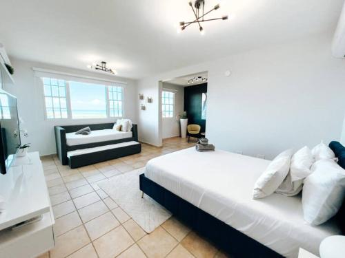 a large bedroom with a bed and a couch at Oasis Village Spacious Apt W/ Ocean View For 9 in Rio Grande
