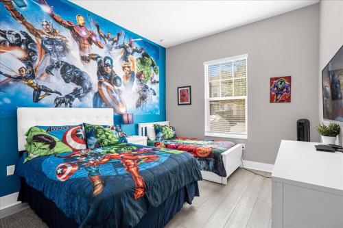 a bedroom with two beds and a marvel mural at Magical Vacation Home 3 min from Disney in Orlando