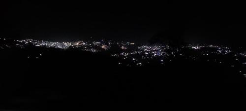 a view of a city lit up at night at TREE HOUSE BY THE CITY ESCAPE in Shimla