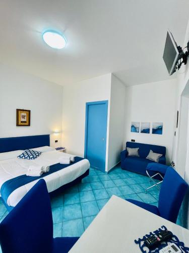a hotel room with two beds and a couch at Eden Holiday in Minori