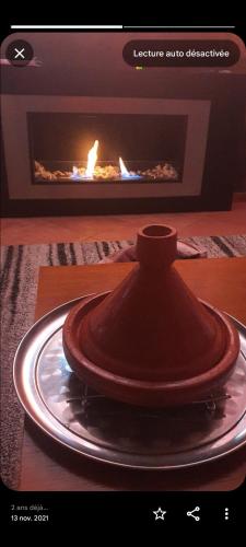 a fireplace with a plate in front of it at Charmant appartement moderne au cœur de Gueliz, Marrakech Lumineux", Cosy", Bien situé in Marrakech