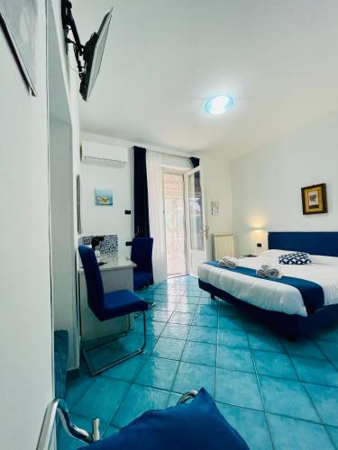 a bedroom with a bed and a desk and a chair at Eden Holiday in Minori
