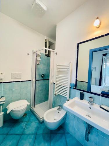 a bathroom with a sink and a toilet and a shower at Eden Holiday in Minori
