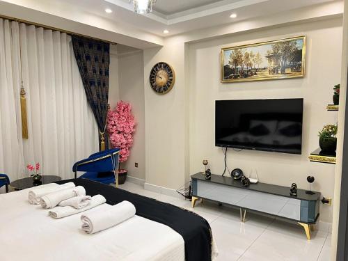 a bedroom with a bed and a tv on a wall at The Golden Horn Deluxe Vip Suite Beyoglu Istanbul in Istanbul
