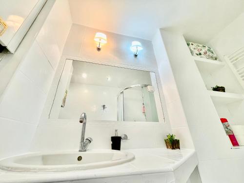 a bathroom with a sink and a mirror at Apartment City Park, 24H Checkin & City Centre w Free Parking in Piešťany