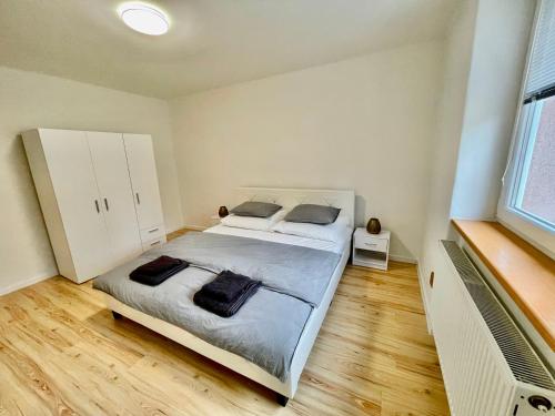 a bedroom with a large bed with two pillows at Apartment City Park, 24H Checkin & City Centre w Free Parking in Piešťany
