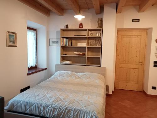 a bedroom with a bed and a book shelf at Casa Weber Levico Terme in Levico Terme