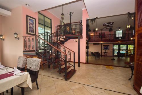 a living room with a spiral staircase in a house at Harbour View Suites in Dar es Salaam