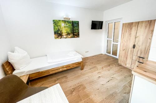 a living room with a bed and a tv at Good Sleep - Appartments in Irxleben