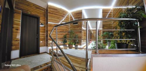 a spiral staircase in a room with plants at Villa Bonaca in Vukovar