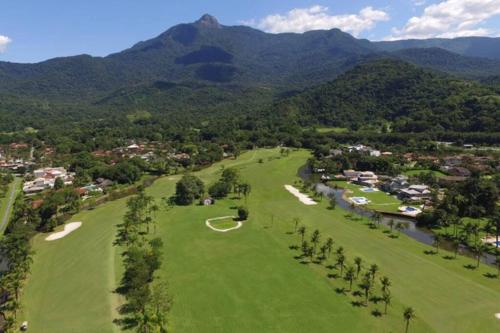 an aerial view of a golf course with mountains in the background at Paraíso de luxo: sua casa dos sonhos in Angra dos Reis