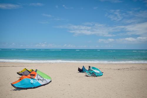 two surfboards laying on top of a sandy beach at Kite Beach Inn in Cabarete