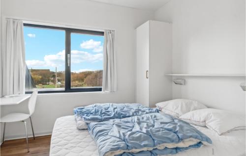 a white bedroom with a bed and a window at 1 Bedroom Stunning Apartment In Fan in Fanø