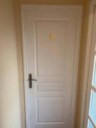 a white door with the number four on it at Le Pontet in Miramont-de-Guyenne
