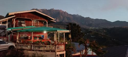 a house with a truck parked in front of it at Almeera Homestay 2 in Kundasang