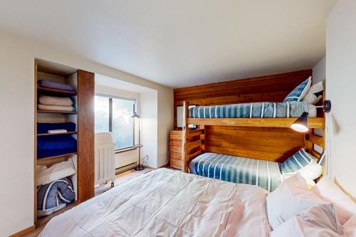 a bedroom with two bunk beds and a window at Huntington Lake Condo #38 in Lakeshore