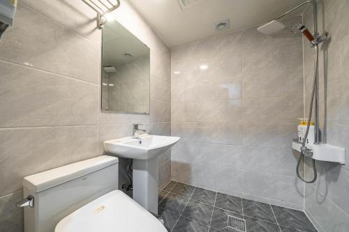 a bathroom with a toilet and a sink and a shower at Hotel Rodem in Incheon