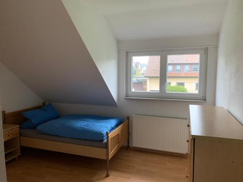 a small room with a bed and a window at FeWo Saier in Althengstett