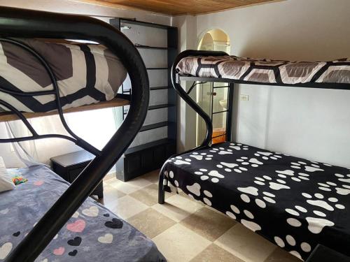 a room with two bunk beds and a chair at Villa Leibrajo in Sasaima