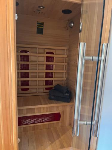 a wine cellar with a glass door to a wine room at Ferienwohnungen am Riedanger in Mayrhofen