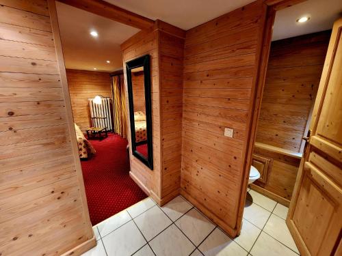 a room with wooden walls and a red carpet at Hotel De l'Europe Basel Mulhouse Airport in Saint-Louis