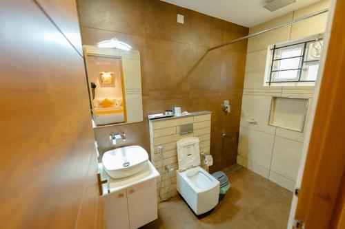 a bathroom with a toilet and a sink at SeaCoast Inn FortKochi in Fort Kochi