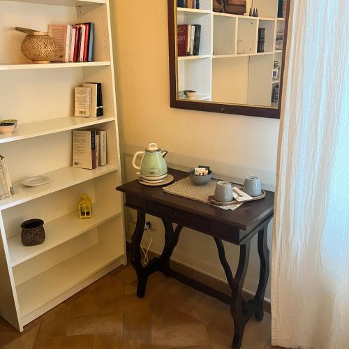 a table in a room with a book shelf at B&B Podere Cottimellino - Montalcino - Val d'Orcia in Montalcino