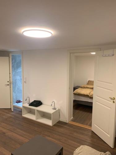 Habitación blanca con cama y mesa blanca en Beautiful 2 rooms apartment in kløfta en Klofta