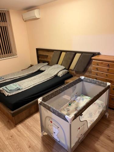 a small bedroom with a bed and a dresser at Лудогорско бижу in Razgrad